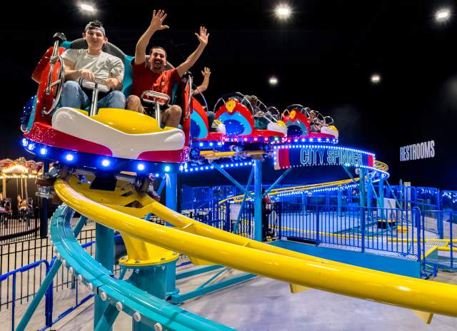 family on an indoor roller coaster