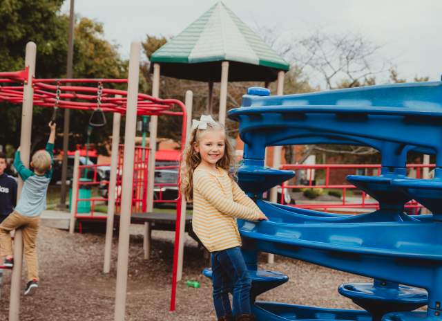 girl on playground equipment