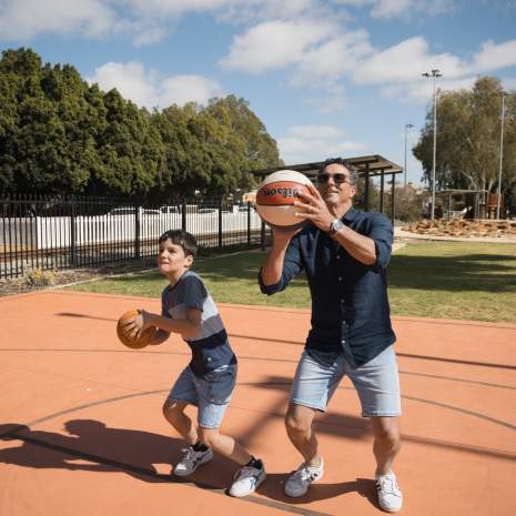 Son and Dad throwing basketball
