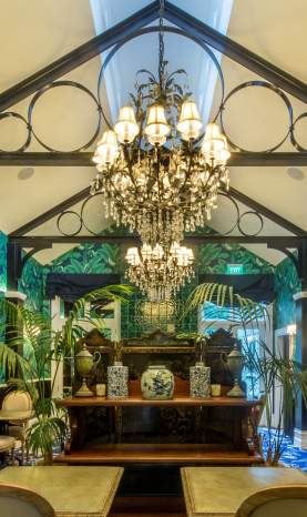 Hulbert House lounge with palm tree decor