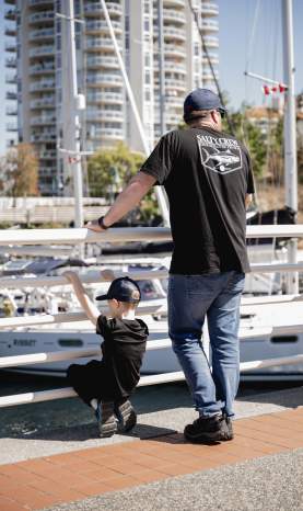 A boy and his dad look over the Nanaimo harbour.