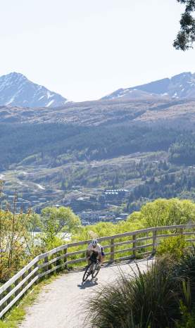 Person biking off road with mountains in the background