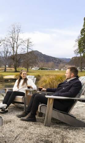 People enjoying at mulled wine by an outdoor fire at Smithy's Smoke House, Millbrook Resort