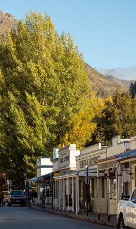 Street lined with old buildings and boutique shops in Arrowtown