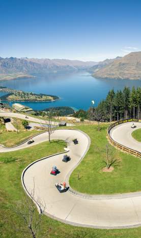 People on the Skyline Queenstown luge with elevated views of Queenstown
