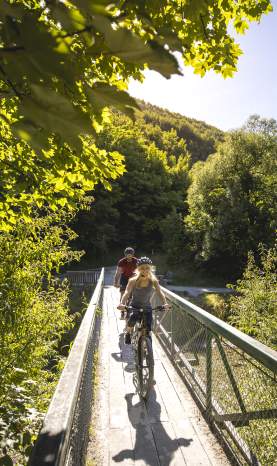 Cyclists biking in Arrowtown during summer