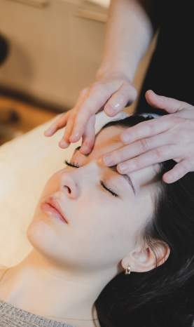 A person getting a facial massage.
