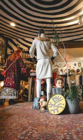 A collection of vintage clothes, decor, and books.