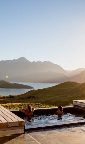 Two women relaxing in the outdoor spa at Aro Ha Wellness Retreat