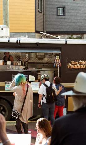 People ordering from a food truck.