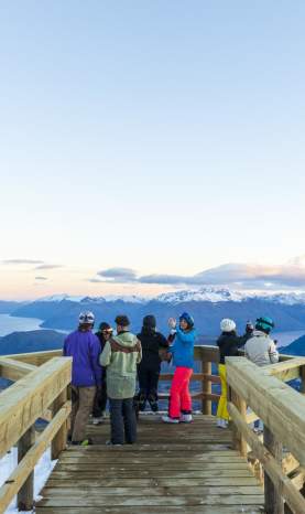 Group of people sightseeing at viewpoint atop of a mountain