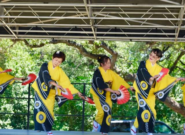 five women perform in traditional dress at CelebrAsia festival hosted by Asian American Resource Center in Austin Texas