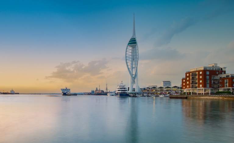 Wide-angle photograph showing Spinnaker Tower and very still waters of Portsmouth Harbour