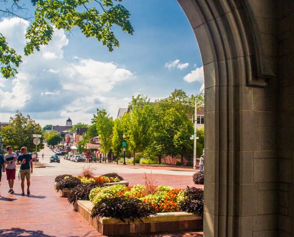 Three men walking toward Sample Gates from Kirkwood