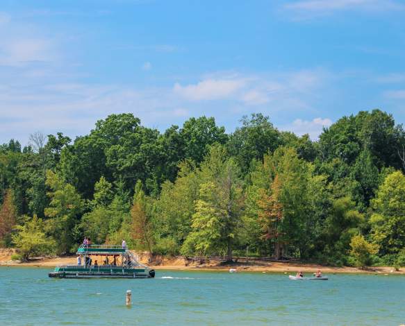 A pontoon and two kayaks on Monroe Lake at the Paynetown SRA