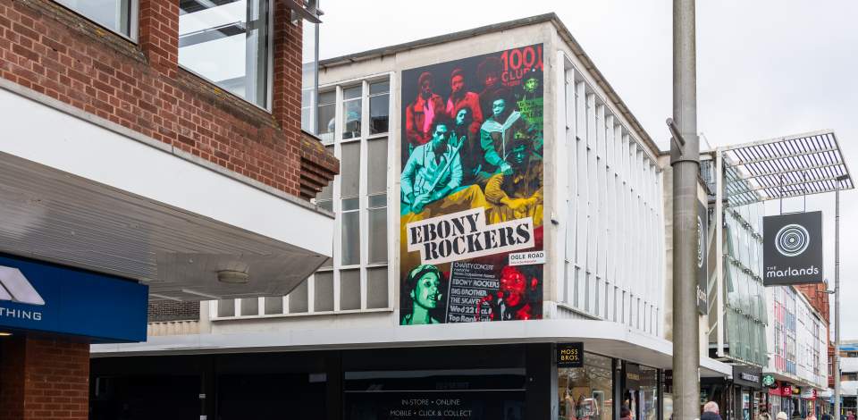 Mural of Ebony Rockers on the side of the Marlands Shopping Centre building