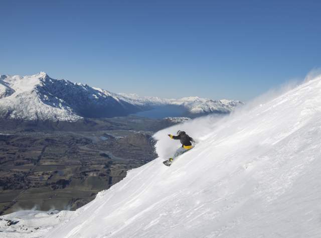 Man snowboarding at Coronet Peak Ski Area
