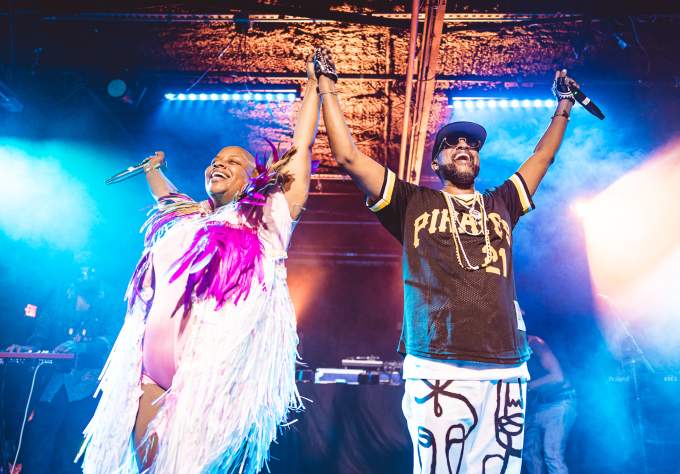 Riders Against the Storm holding hands in the air on stage