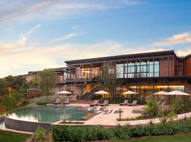 External building overlooking pool with umbrellas