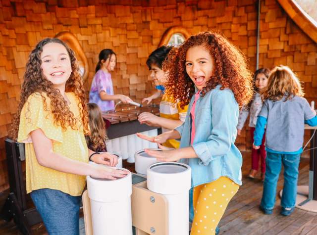 Two girls laughing and playing at the DoSeum