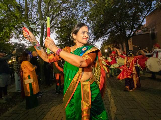 Woman dancing dressed in traditional Indian attire