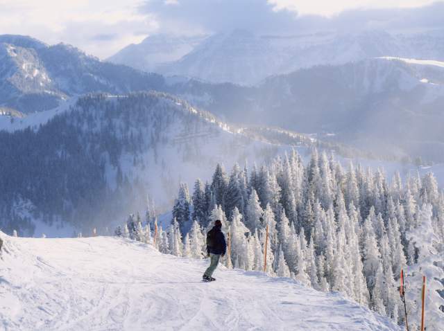 Snowboarder going down the Great Western at Brighton Resort, UT.