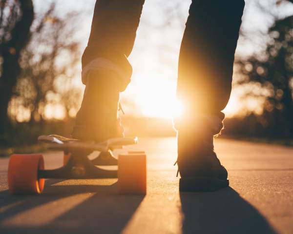 a picture of a person's legs and a skateboard