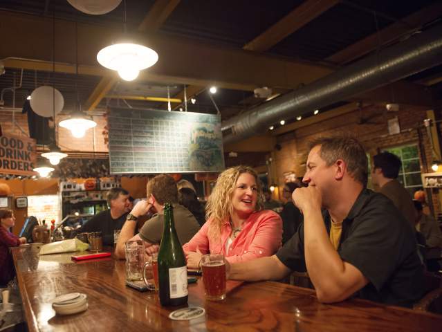 Couple having drinks at the bar at Arbor Brewing Company in Ypsilanti