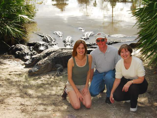 Gatorland family kneeling next to alligators