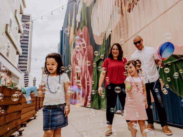 Parents and Girls at The Landing playing with bubbles