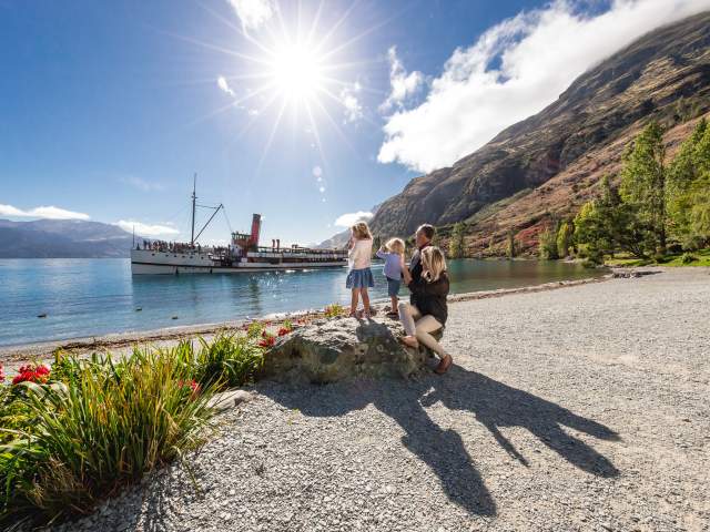Family at Walter Peak watching the TSS Earnslaw steamship