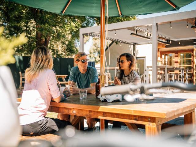 Group of people relaxing at a table at a pub