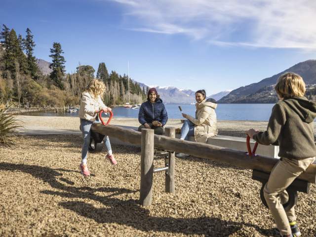 Family playing on a playground in winter