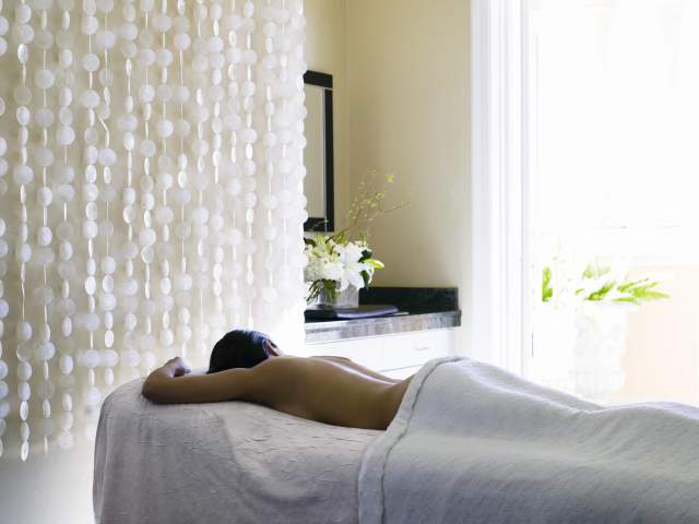 The Ritz-Carlton Spa, Orlando, Grande Lakes woman at the spa getting a massage