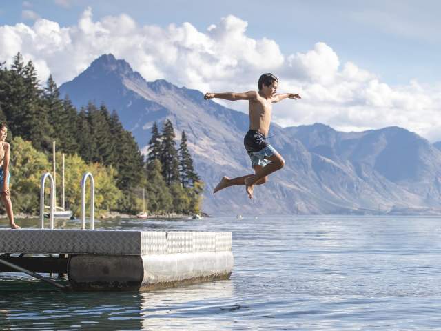 Boy jumping into Lake Whakatipu