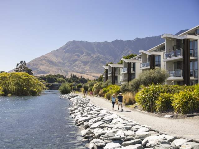Couple walking in Kelvin Heights with the Remarkables mountain in the background
