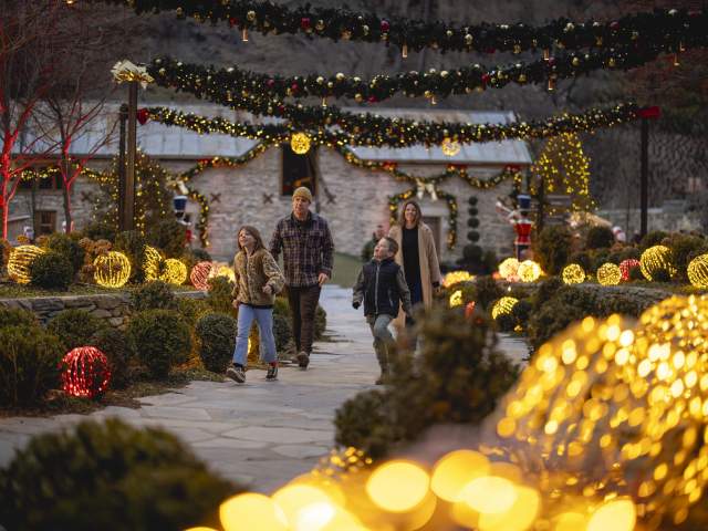 A family walking in among light up decortions