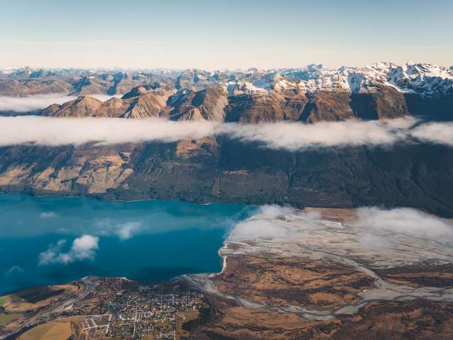 Aerial photo of Glenorchy township with huge mountains in the background
