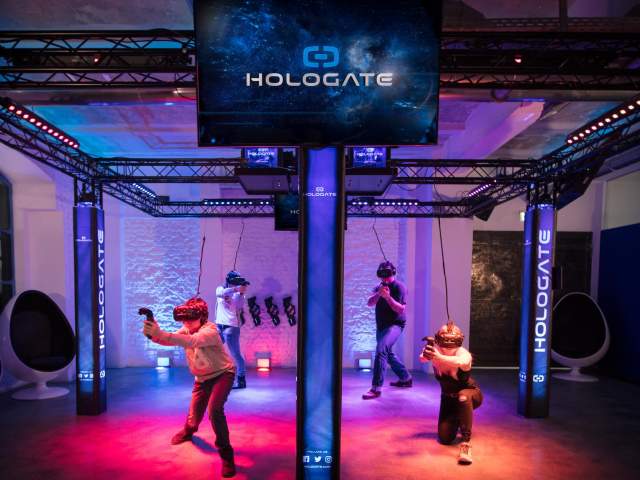 People in a colourful virtual reality area