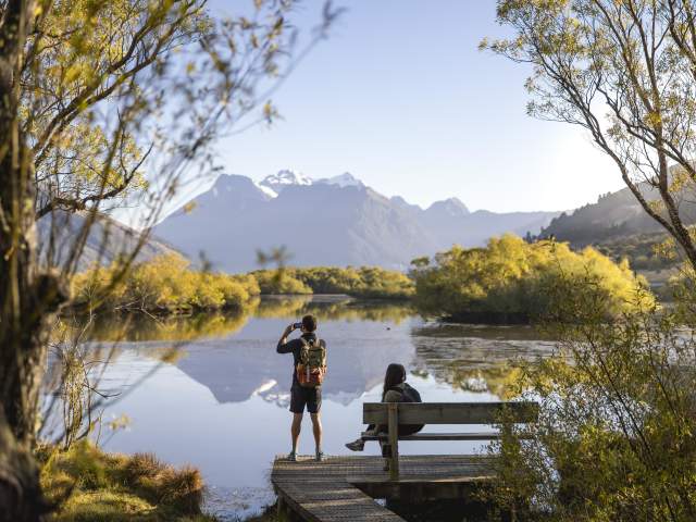 People enjoying the views of lake and mountains at the Glenorchy Lagoon Walkway