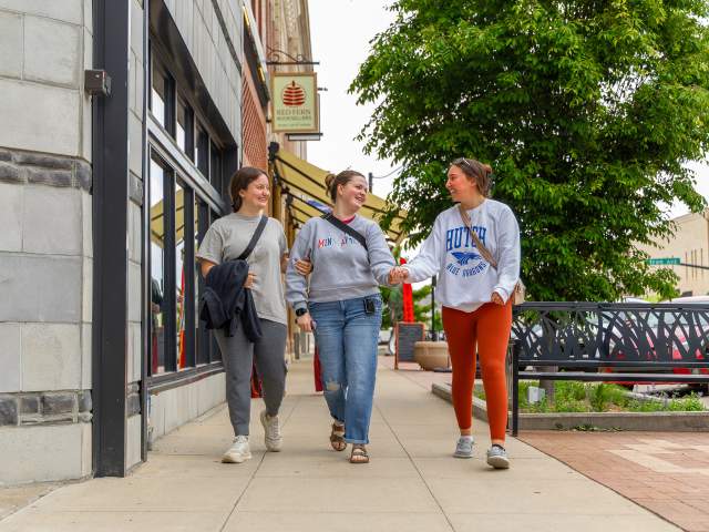 A group of girls walking in downtown Salina Kansas, laughing and smiling