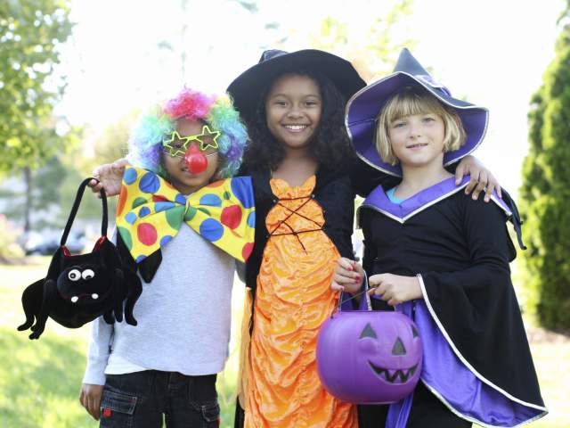 three young girls posing in their Halloween costumes