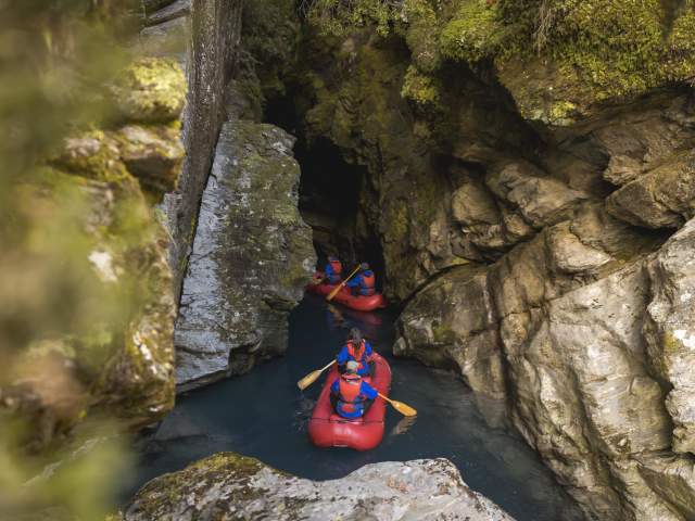 Group of people on inflatable Funyaks going into a chasm