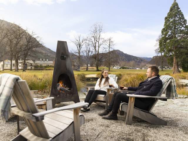 People enjoying at mulled wine by an outdoor fire at Smithy's Smoke House, Millbrook Resort