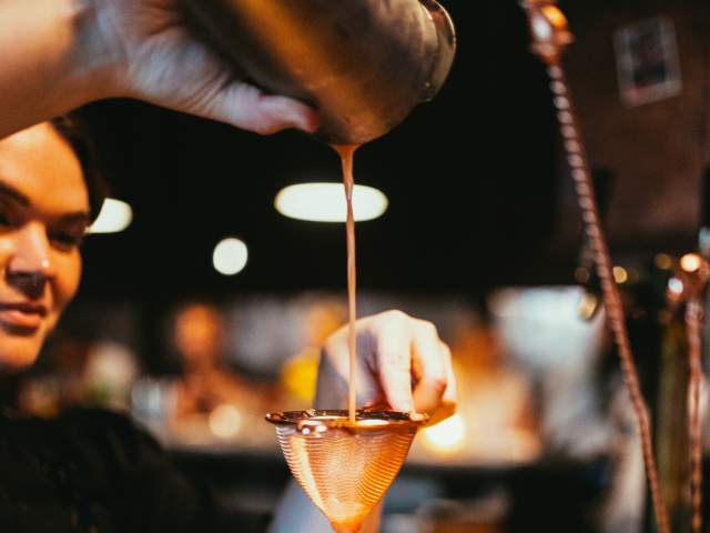 The Courtesy Bar interior bartender