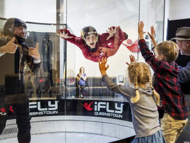 Woman flying in the wind tunnel at iFly Queenstown