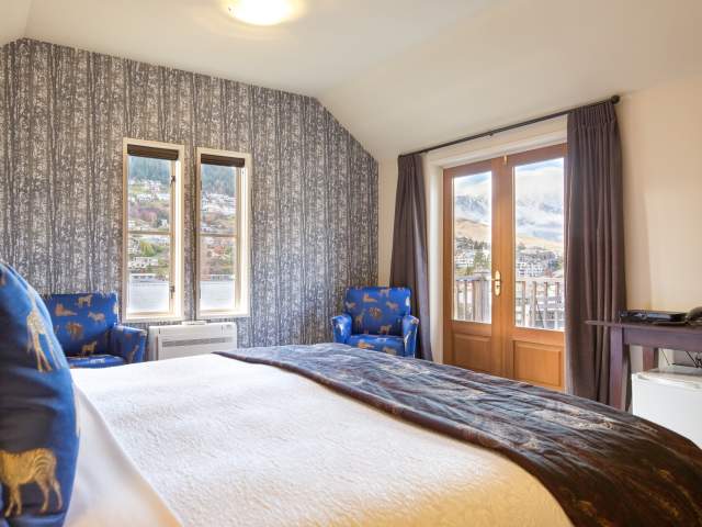Cosy room at the The Dairy Private Hotel, with views of the Remarkables mountains covered in snow.