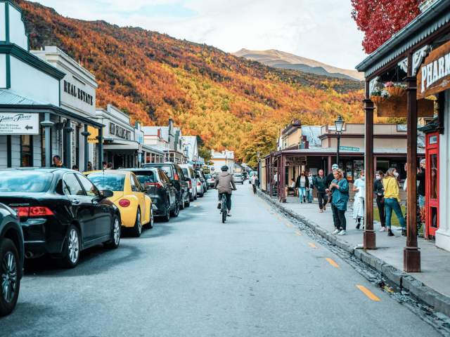 Person biking in Arrowtown during Autumn