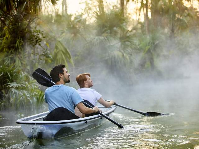 A gay couple kayaking through King's Landing at Wekiva River