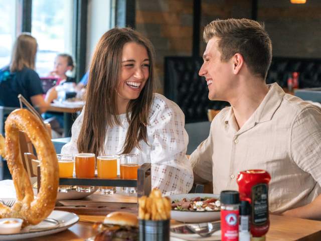 Couple enjoying beer and food at Grateful Goat